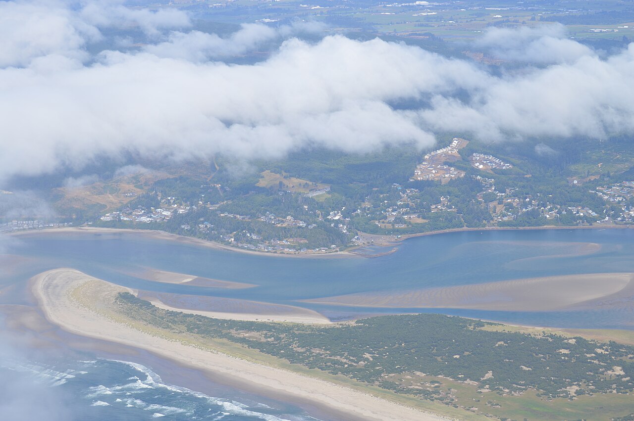 Aerial photo of a coastal bay and sand spit used as the card preview. This plan has no site map on the page.